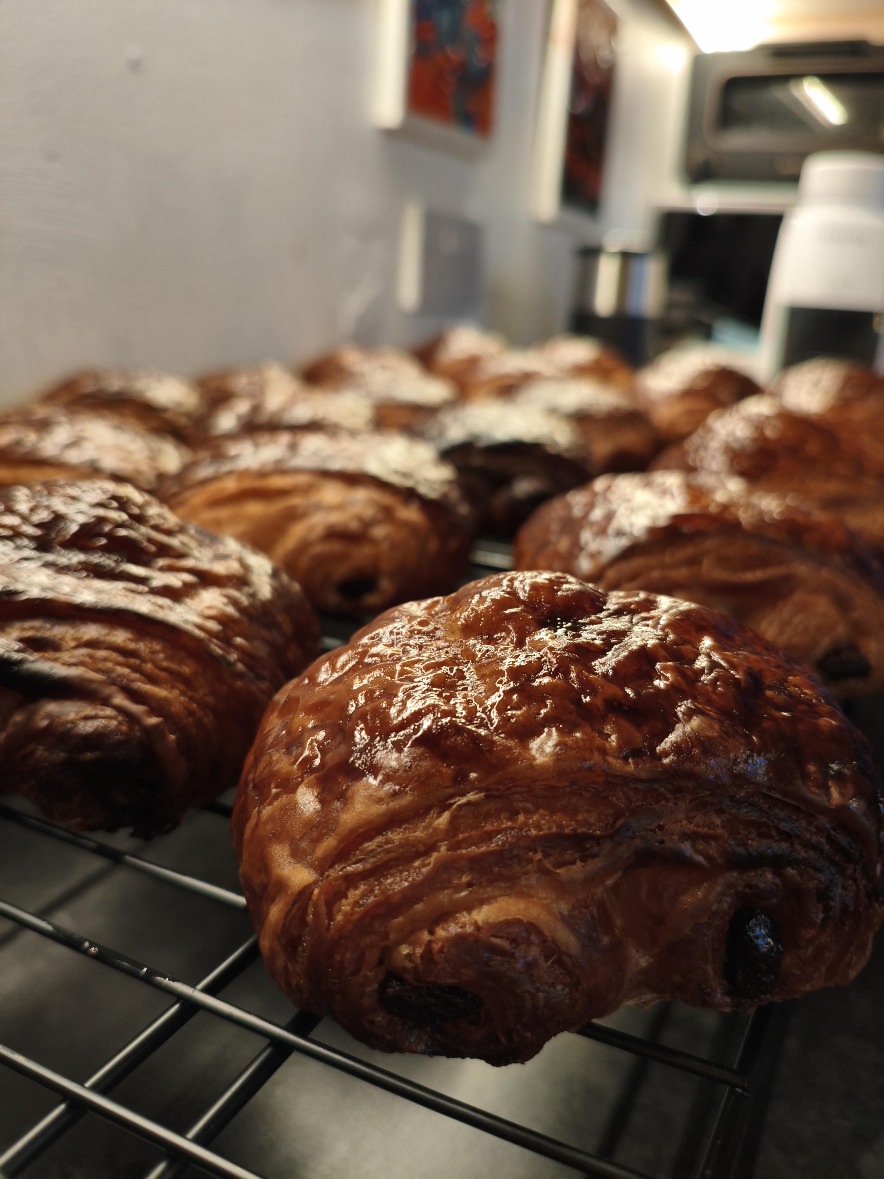 Fresh Pain au Chocolat on a cooling rack, studio lighting